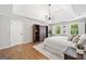 Bright and airy main bedroom with neutral paint, decorative shelving and abundant natural light at 335 S Satinwood Pl, Roswell, GA 30076