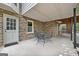 Covered patio area with brick columns, seating, and access to the backyard at 335 S Satinwood Pl, Roswell, GA 30076