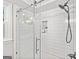 Updated shower with subway tile and a sleek glass door at 335 S Satinwood Pl, Roswell, GA 30076