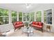 Bright sunroom with multiple windows that provide natural light and green tree views at 335 S Satinwood Pl, Roswell, GA 30076