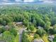 Scenic aerial view of a home nestled amongst lush greenery and mature trees in a tranquil setting at 1625 Clark Lake Nw, Acworth, GA 30102