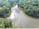 Scenic aerial view of a tree-lined lake highlighting the natural beauty and serene waterfront setting at 1625 Clark Lake Nw, Acworth, GA 30102