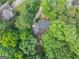 Aerial view of the home surrounded by lush greenery, showcasing its secluded location at 1625 Clark Lake Nw, Acworth, GA 30102