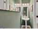 Powder room with decorative walls, vanity, and mirror at 1625 Clark Lake Nw, Acworth, GA 30102