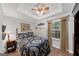Bright bedroom features a trey ceiling, ceiling fan, carpet, and natural light from a large window at 1625 Clark Lake Nw, Acworth, GA 30102