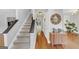 Inviting foyer features a staircase, hardwood floors, and modern decor, creating a warm welcome at 1625 Clark Lake Nw, Acworth, GA 30102