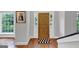 Bright foyer with hardwood floors, windows and a wooden front door filled with decorative elements at 1625 Clark Lake Nw, Acworth, GA 30102