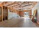 Unfinished basement space featuring open ceiling with insulation and door to the backyard at 155 Carrolls Way, Fayetteville, GA 30215