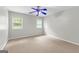 This bedroom includes neutral walls, carpet and a blue ceiling fan at 155 Carrolls Way, Fayetteville, GA 30215