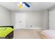Spacious bedroom featuring neutral carpet, ceiling fan, and double closets at 155 Carrolls Way, Fayetteville, GA 30215