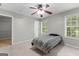 This light and bright bedroom features a ceiling fan and a door leading to a closet at 155 Carrolls Way, Fayetteville, GA 30215