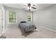 This bedroom includes neutral walls, carpet and a ceiling fan at 155 Carrolls Way, Fayetteville, GA 30215
