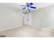 This bedroom includes neutral walls, carpet and a blue ceiling fan at 155 Carrolls Way, Fayetteville, GA 30215