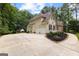 Long driveway leading to a two-car garage and an exterior view of the home's side at 155 Carrolls Way, Fayetteville, GA 30215