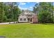 Charming two-story home with a manicured lawn and inviting curb appeal with mature trees at 155 Carrolls Way, Fayetteville, GA 30215