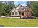 Charming two-story home with a manicured lawn and inviting curb appeal with mature trees at 155 Carrolls Way, Fayetteville, GA 30215