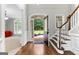 Inviting foyer with hardwood floors, staircase, and an open door view to the outdoors at 155 Carrolls Way, Fayetteville, GA 30215