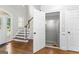 Foyer featuring wood floors, staircase, white railing and trim, and an open door to a storage space at 155 Carrolls Way, Fayetteville, GA 30215