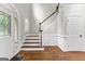Traditional foyer with hardwood floors, staircase, and natural light from the front door at 155 Carrolls Way, Fayetteville, GA 30215