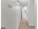Hallway with neutral carpet leads to laundry room and other rooms within the home at 155 Carrolls Way, Fayetteville, GA 30215