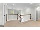 Bright hallway featuring a staircase with white railings and a door leading outside at 155 Carrolls Way, Fayetteville, GA 30215