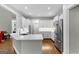 Kitchen with white cabinets, stainless steel appliances, and view to living room at 155 Carrolls Way, Fayetteville, GA 30215
