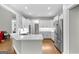 Modern kitchen featuring white cabinets, marble countertops, and stainless-steel appliances at 155 Carrolls Way, Fayetteville, GA 30215