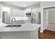 New kitchen features white cabinets, marble countertops, and stainless-steel appliances at 155 Carrolls Way, Fayetteville, GA 30215