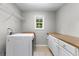 Laundry room featuring tiled floors, countertop, cabinets, and laundry machines at 155 Carrolls Way, Fayetteville, GA 30215