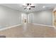 Neutral living room with tiled floor, ceiling fan, recessed lighting, and entrances to other rooms at 155 Carrolls Way, Fayetteville, GA 30215