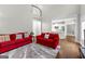 Spacious living room boasts hardwood floors, gray walls, and stylish red sofas at 155 Carrolls Way, Fayetteville, GA 30215