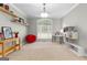 Bright living room featuring carpeted floors, a large window, and a neutral color palette at 155 Carrolls Way, Fayetteville, GA 30215