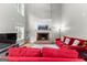 Comfortable living area with a fireplace, large windows, and cozy red sofas at 155 Carrolls Way, Fayetteville, GA 30215