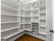 Well-organized walk-in pantry with ample shelving, wire basket storage, and hardwood floors at 155 Carrolls Way, Fayetteville, GA 30215