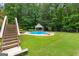 Tranquil backyard oasis featuring a gazebo, pool, and lounge chairs perfect for relaxing at 155 Carrolls Way, Fayetteville, GA 30215