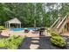 Beautiful backyard with a sparkling pool, gazebo, lush landscaping, and inviting lounge area at 155 Carrolls Way, Fayetteville, GA 30215