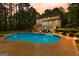 Backyard oasis featuring a large in-ground pool, a patio, and mature trees at 155 Carrolls Way, Fayetteville, GA 30215
