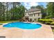 Backyard features a large, inviting pool, deck, and lush landscaping, creating a private oasis at 155 Carrolls Way, Fayetteville, GA 30215