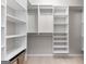 Spacious walk-in closet with multiple shelving units and a hanging rod for optimal organization at 155 Carrolls Way, Fayetteville, GA 30215