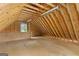 Large unfinished attic with exposed beams, natural light, and ample storage at 344 Mckibben Dr, Locust Grove, GA 30248