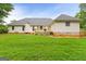 Expansive backyard with deck, mature trees, and lush lawn, ideal for outdoor living and entertaining at 344 Mckibben Dr, Locust Grove, GA 30248