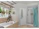 Bright bathroom featuring a soaking tub and tiled shower with glass door at 344 Mckibben Dr, Locust Grove, GA 30248