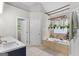 Bright bathroom features a soaking tub, hanging plants and tile floor at 344 Mckibben Dr, Locust Grove, GA 30248
