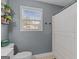 Gray bathroom with shower curtain and toilet at 344 Mckibben Dr, Locust Grove, GA 30248