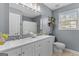 Bathroom features a double vanity, a large mirror, and gray walls at 344 Mckibben Dr, Locust Grove, GA 30248