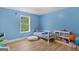 Bright bedroom features a single bed, wood floors, and a white storage unit with toys at 344 Mckibben Dr, Locust Grove, GA 30248