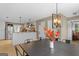 Open dining area with pendant lighting overlooking the kitchen and Gathering room at 344 Mckibben Dr, Locust Grove, GA 30248