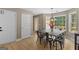 Sun-filled dining room with wood floors, large windows, and contemporary light fixture at 344 Mckibben Dr, Locust Grove, GA 30248
