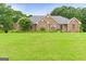 A charming brick home with a well-manicured lawn and beautiful landscaping at 344 Mckibben Dr, Locust Grove, GA 30248