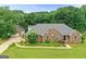 A beautiful, single-story brick house with lush landscaping and a well-manicured lawn at 344 Mckibben Dr, Locust Grove, GA 30248